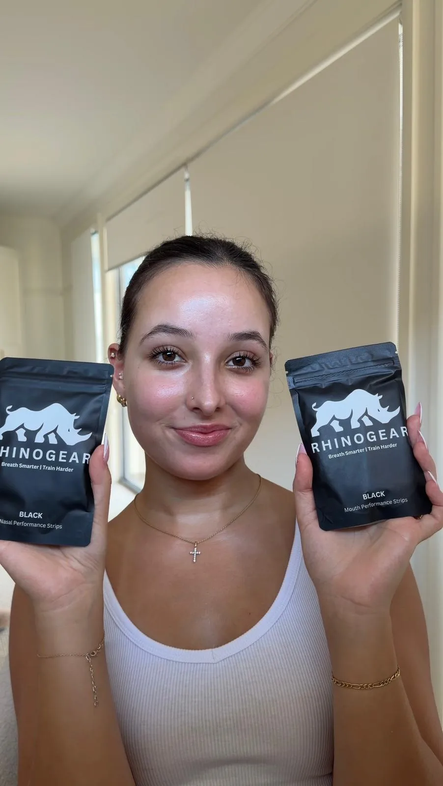 Customer holding RhinoGear nasal strips and mouth tape performance strips pouches side by side