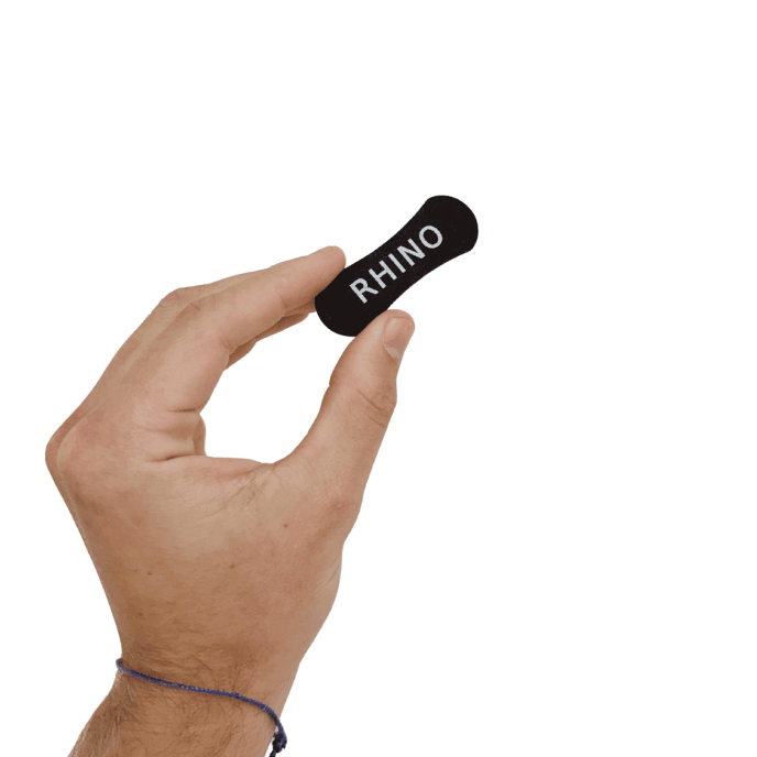 RhinoGear nasal strip held between thumb and forefinger
