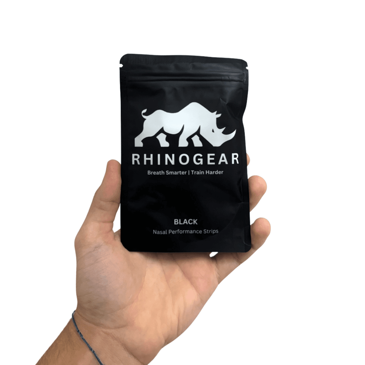 Hand holding a sealed RhinoGear nasal strip packet