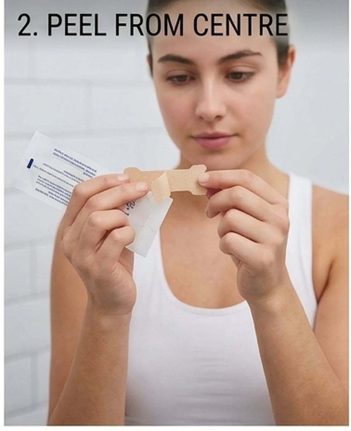 How to apply nasal strips step 2 — peel the nose strip from the centre of the backing to protect the spring band